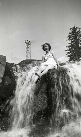 Vachon Irène assise sur une roche dans une chute