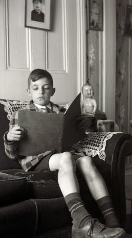 Un garcon qui lit un livre