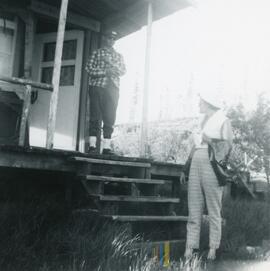 Un homme et une femme discutant à l’entrée d’une maison